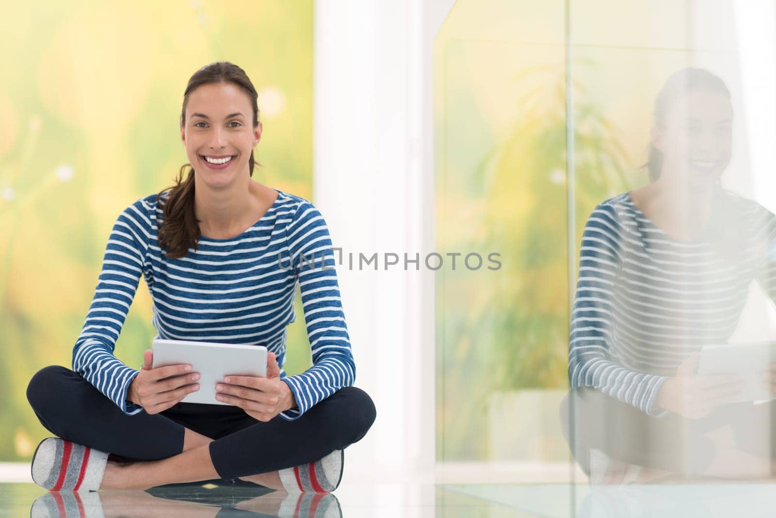 beautiful young women using tablet computer on the floor at home