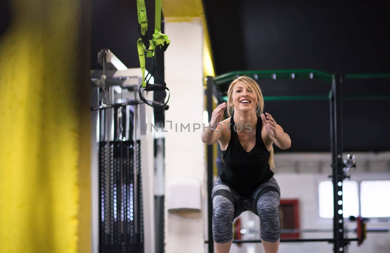 young athletic woman training  jumping on fit box at cross fitness gym
