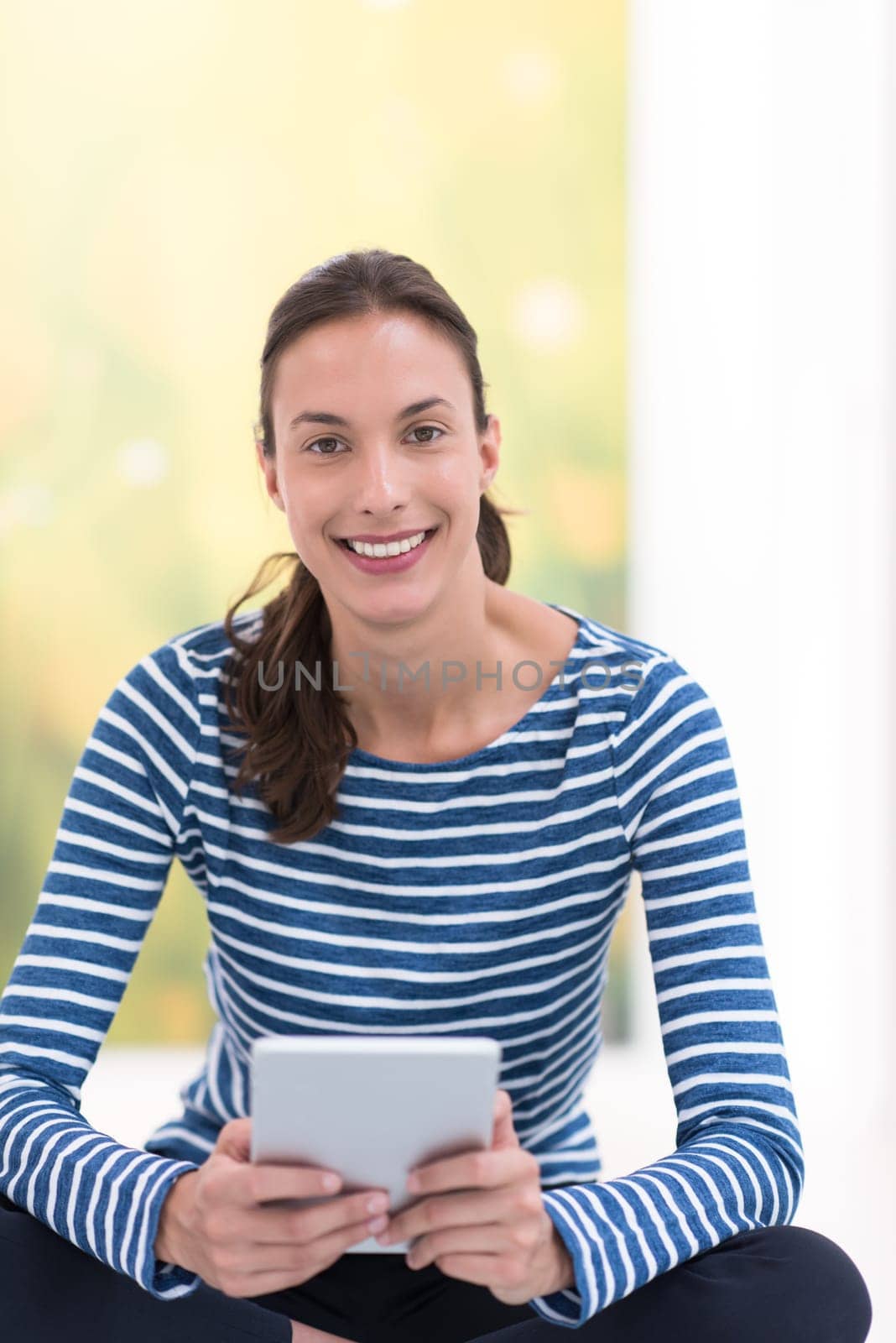 beautiful young women using tablet computer on the floor at home