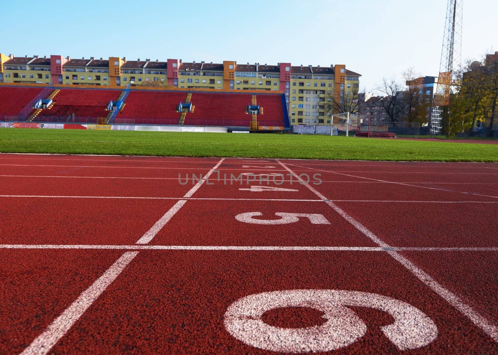 Red athletic track treadmill at the stadium with the numbering.