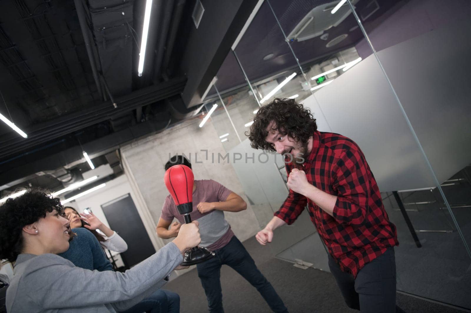 multiethnics startup business team of software developers having fun while boxing at office,excited diverse employees laughing enjoying funny activity at work break, creative friendly workers playing game together