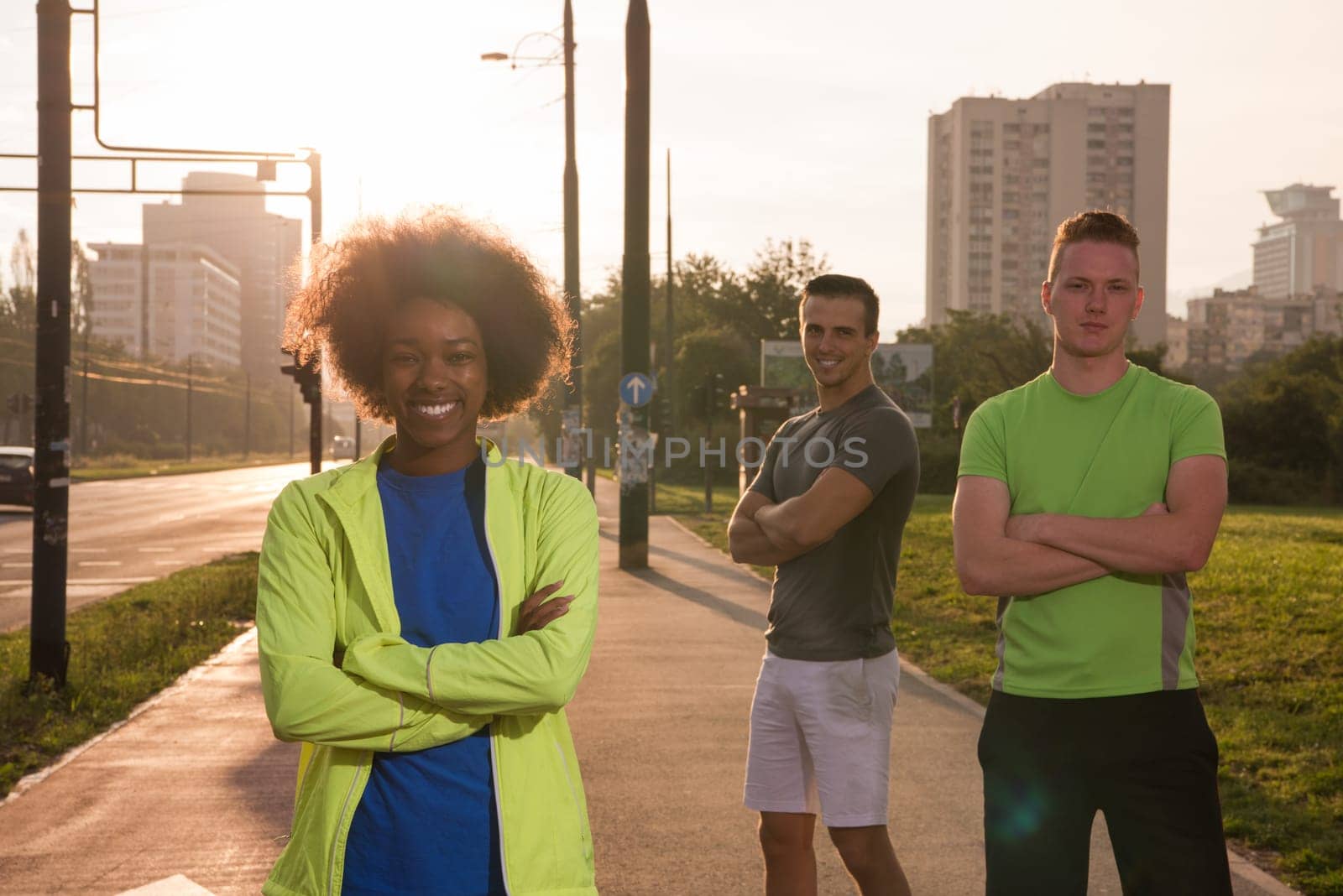 Portrait of multi-ethnic group of young people on the jogging beautiful summer evening as the sun sets over the city