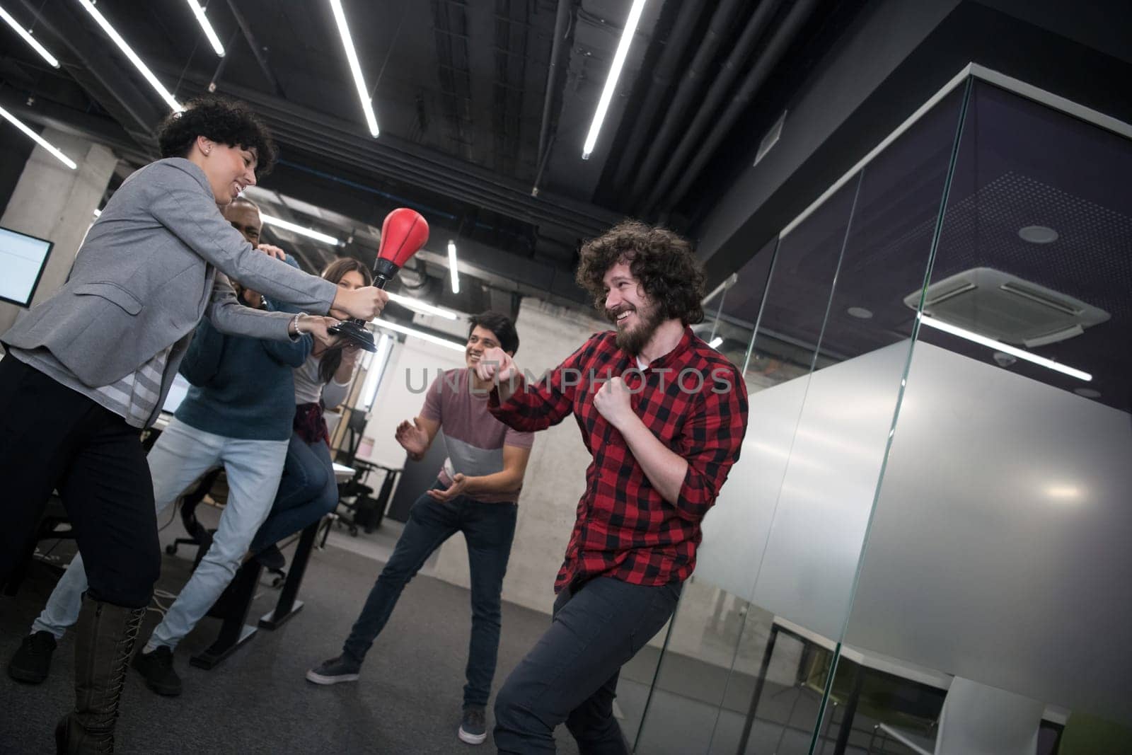 multiethnics startup business team of software developers having fun while boxing at office,excited diverse employees laughing enjoying funny activity at work break, creative friendly workers playing game together