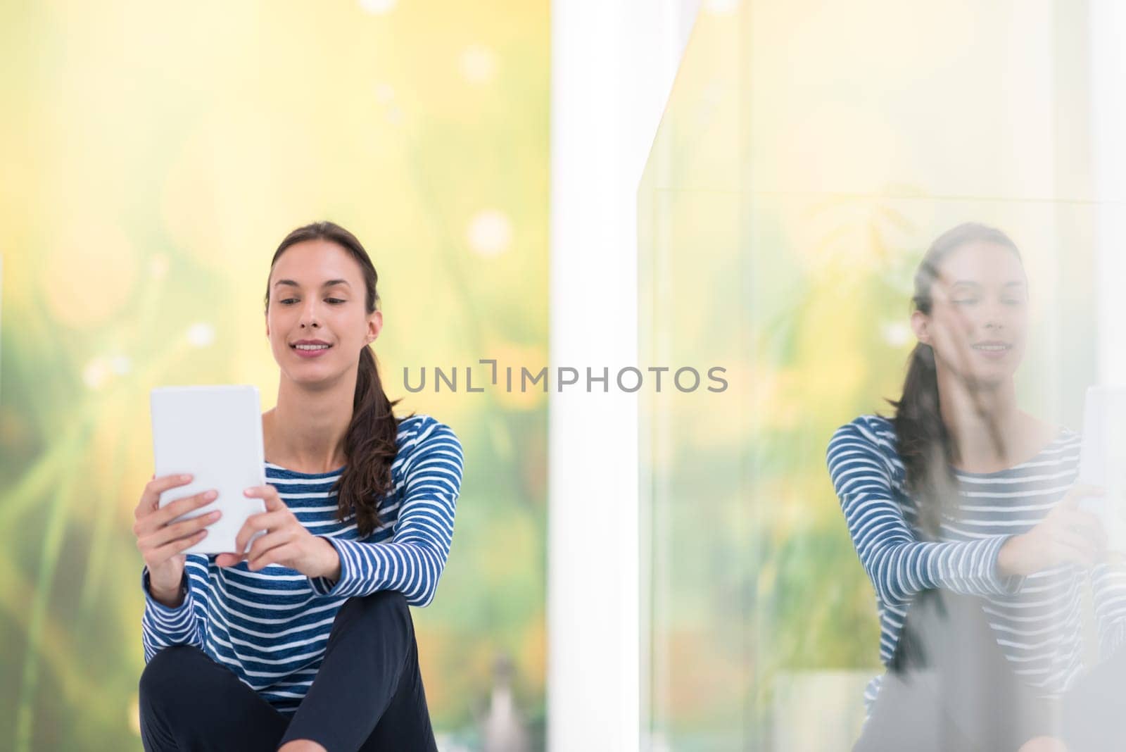beautiful young women using tablet computer on the floor at home