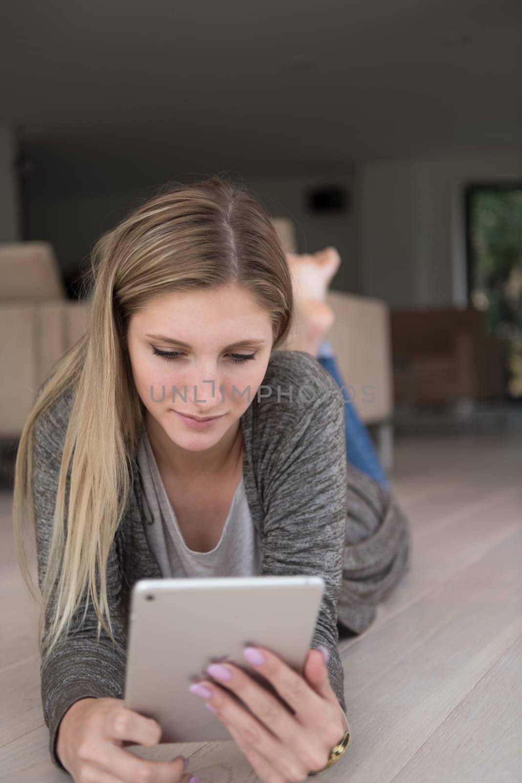 beautiful young women used tablet computer on the floor of her luxury home