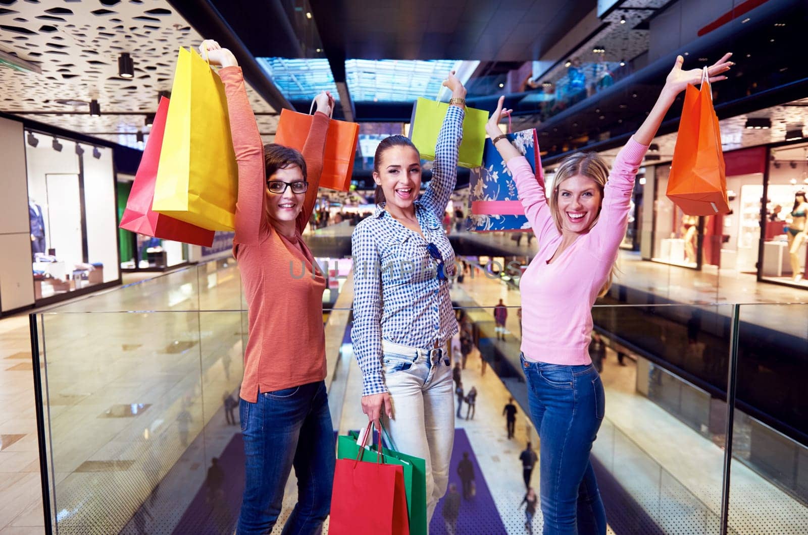 happy young girls in  shopping mall, friends having fun together