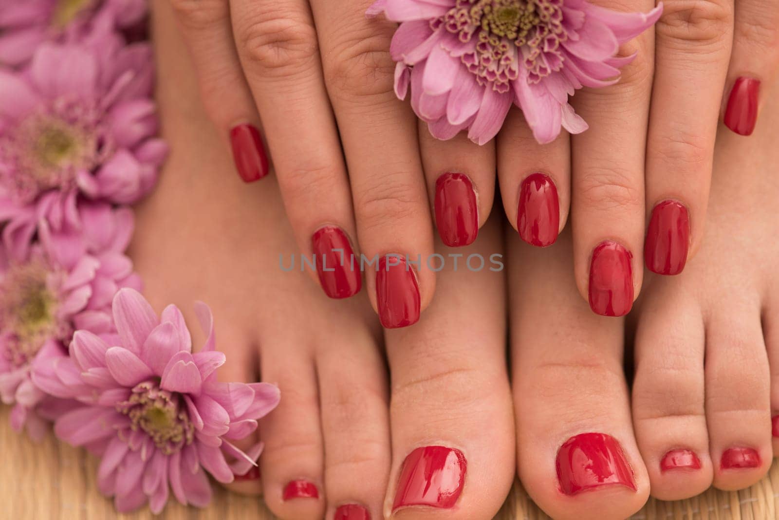 Closeup photo of a female feet and hands at spa salon on pedicure and manicure procedure
