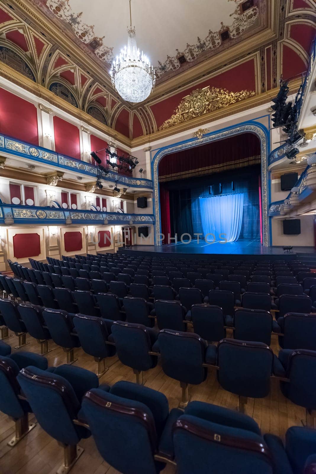 empty theater stage curtain with dramatic lights