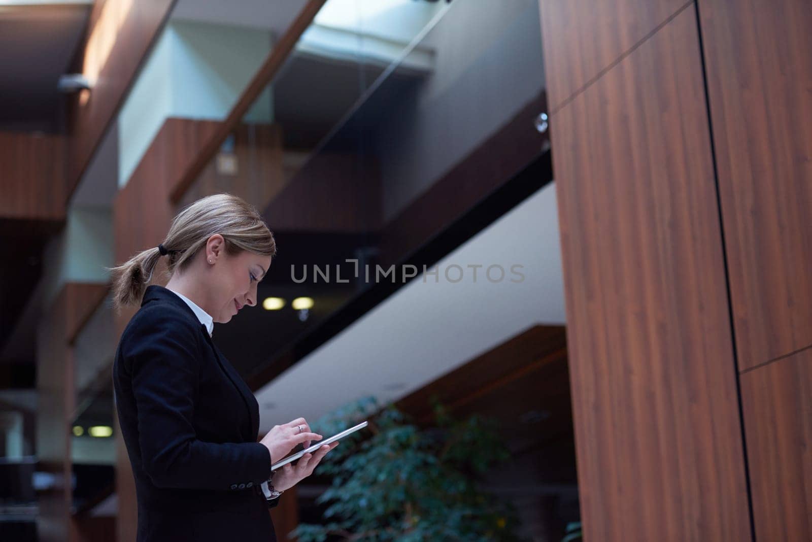 corporate business woman working on tablet computer  at modern office interior