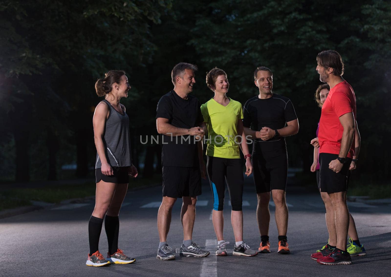 group of healthy people jogging in city park, runners team on morning training