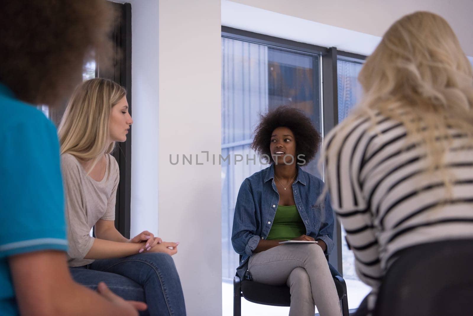 Multiethnic startup business team on meeting in modern bright office interior brainstorming, working on laptop and tablet computer