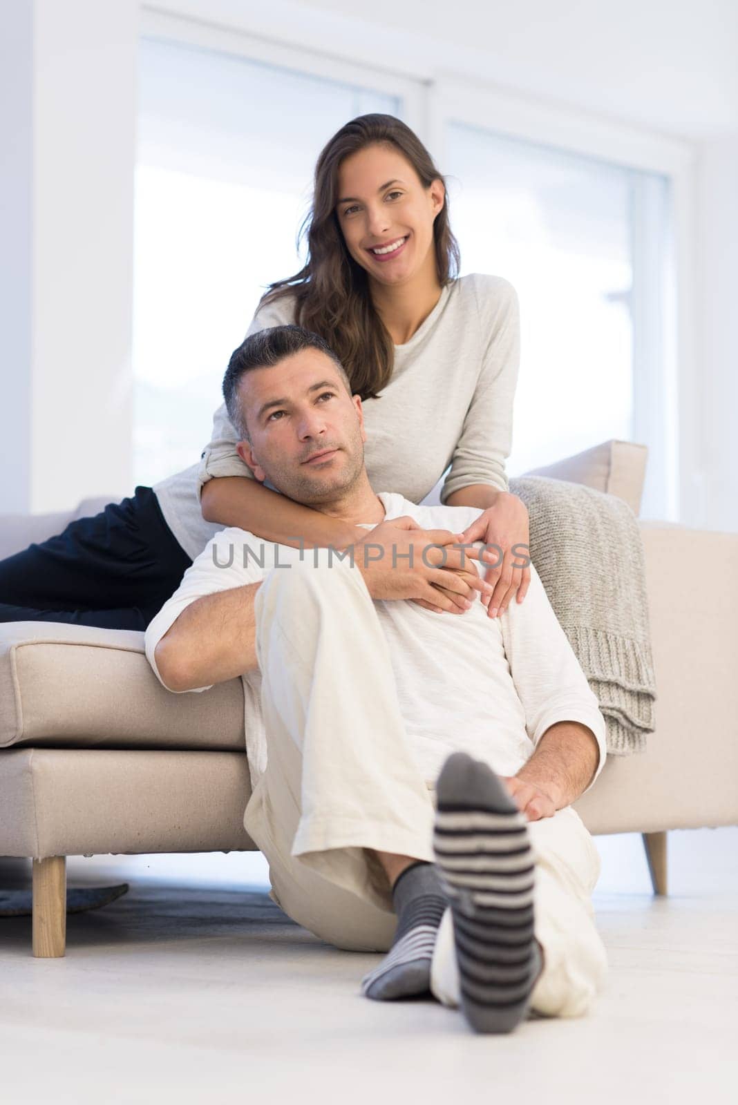 Portrait of a happy young beautiful couple hugging in their new home