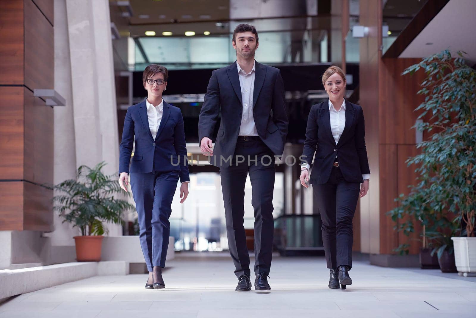 young business people team walking, group of people on modern office hall interior