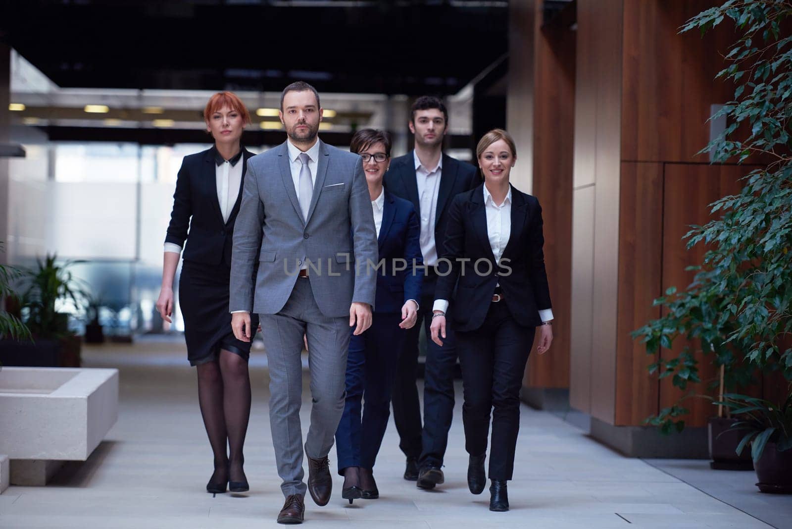 young business people team walking, group of people on modern office hall interior