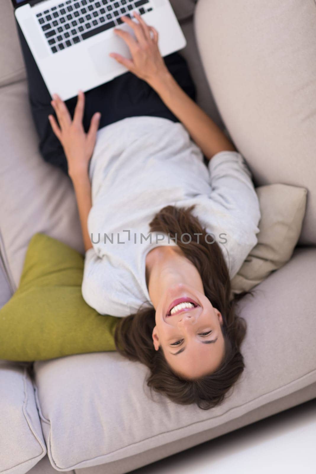 Young woman using her laptop computer in her luxury modern home top view