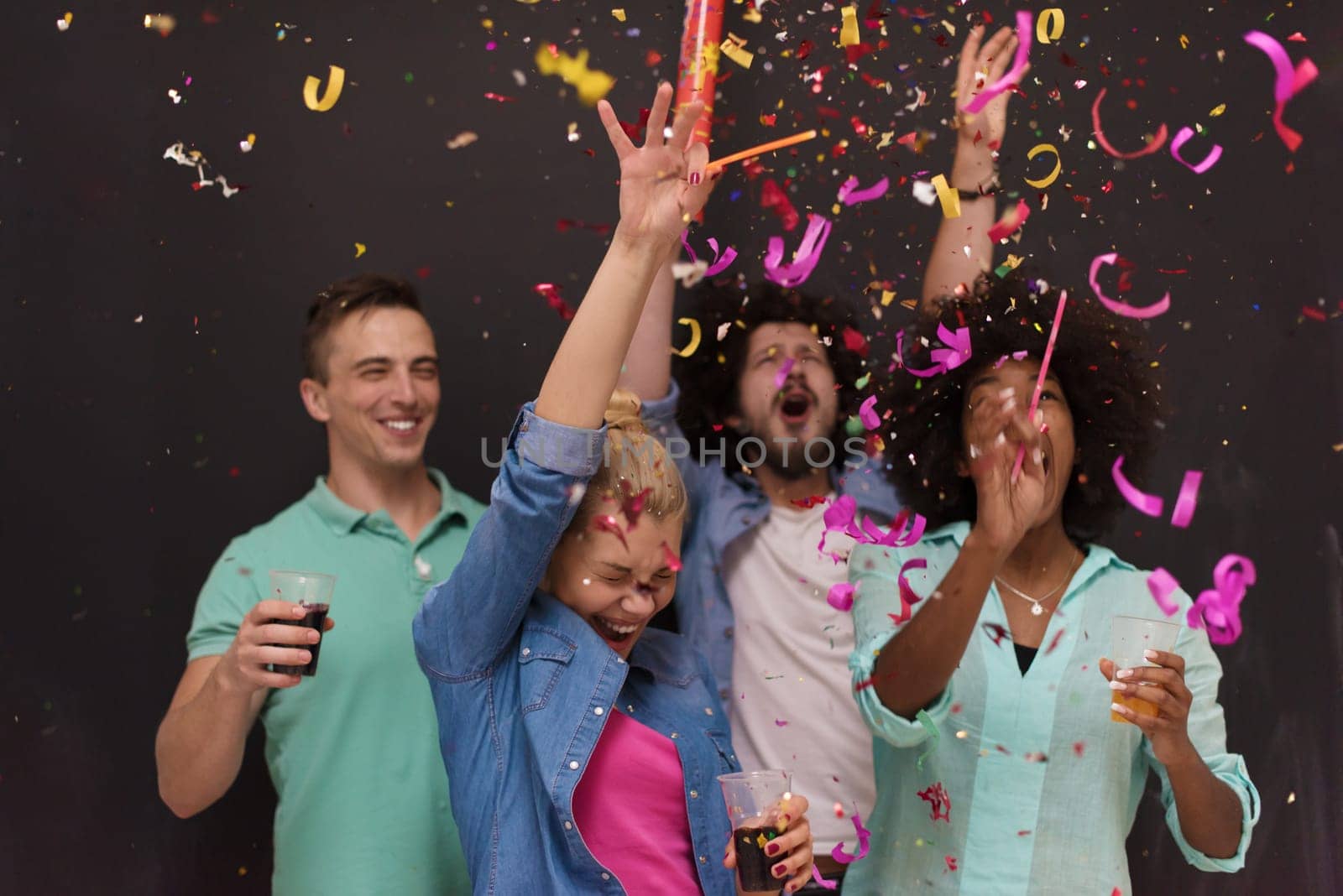 confetti party Multiethnics group of happy young people celebrating new year eve while dancing and have fun at home
