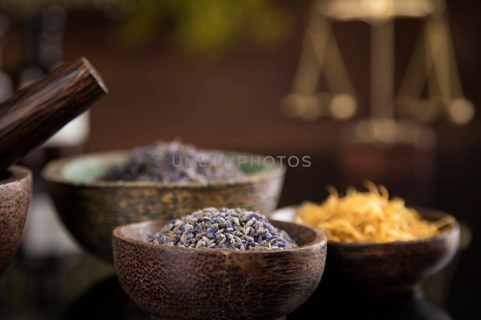 Alternative health, fresh herbal and mortar in black mirror background