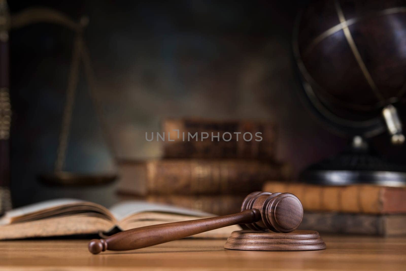 Law theme, mallet of judge, wooden gavel, globe background