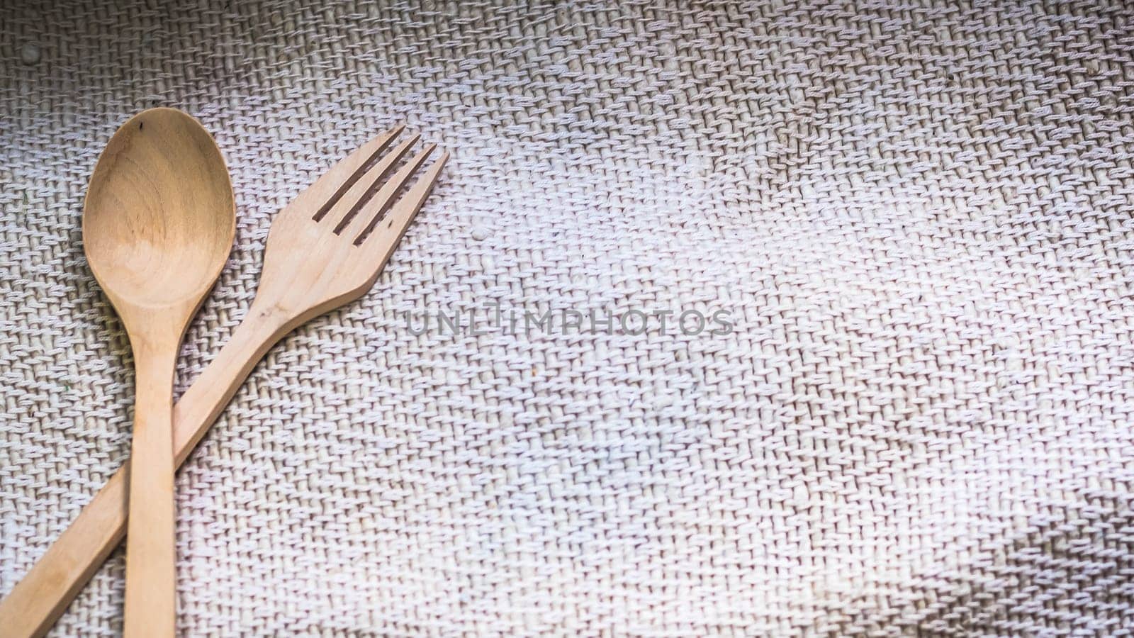 Male hands hold a fork over blur green background for food cooking