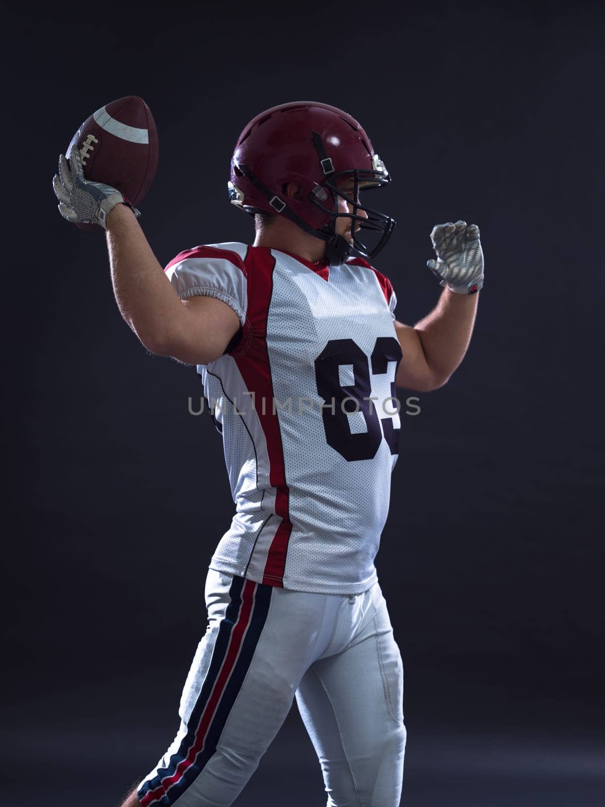 one quarterback american football player throwing ball isolated on gray background