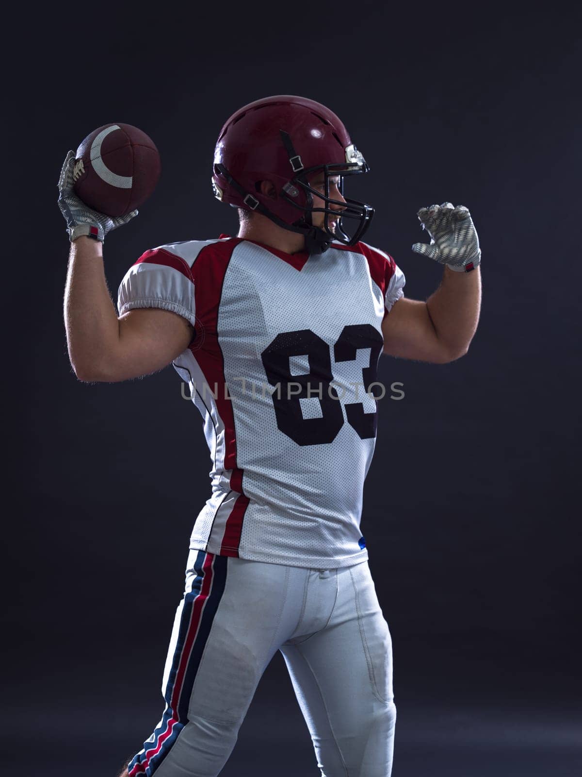 one quarterback american football player throwing ball isolated on gray background