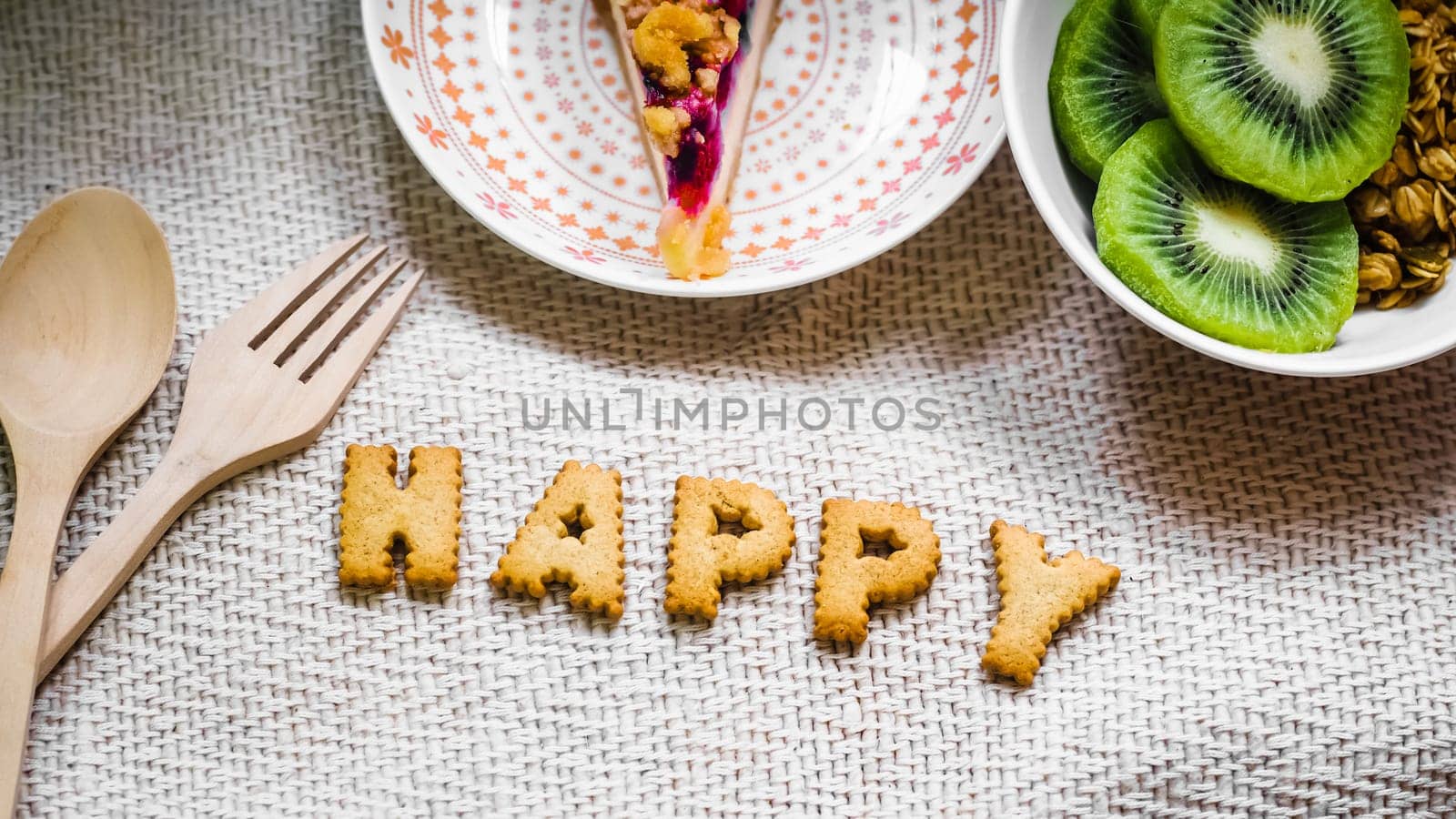 Cookies in the form of the alphabet prospect. Happy from homemade cookies on dark white background. Happy cookies concept