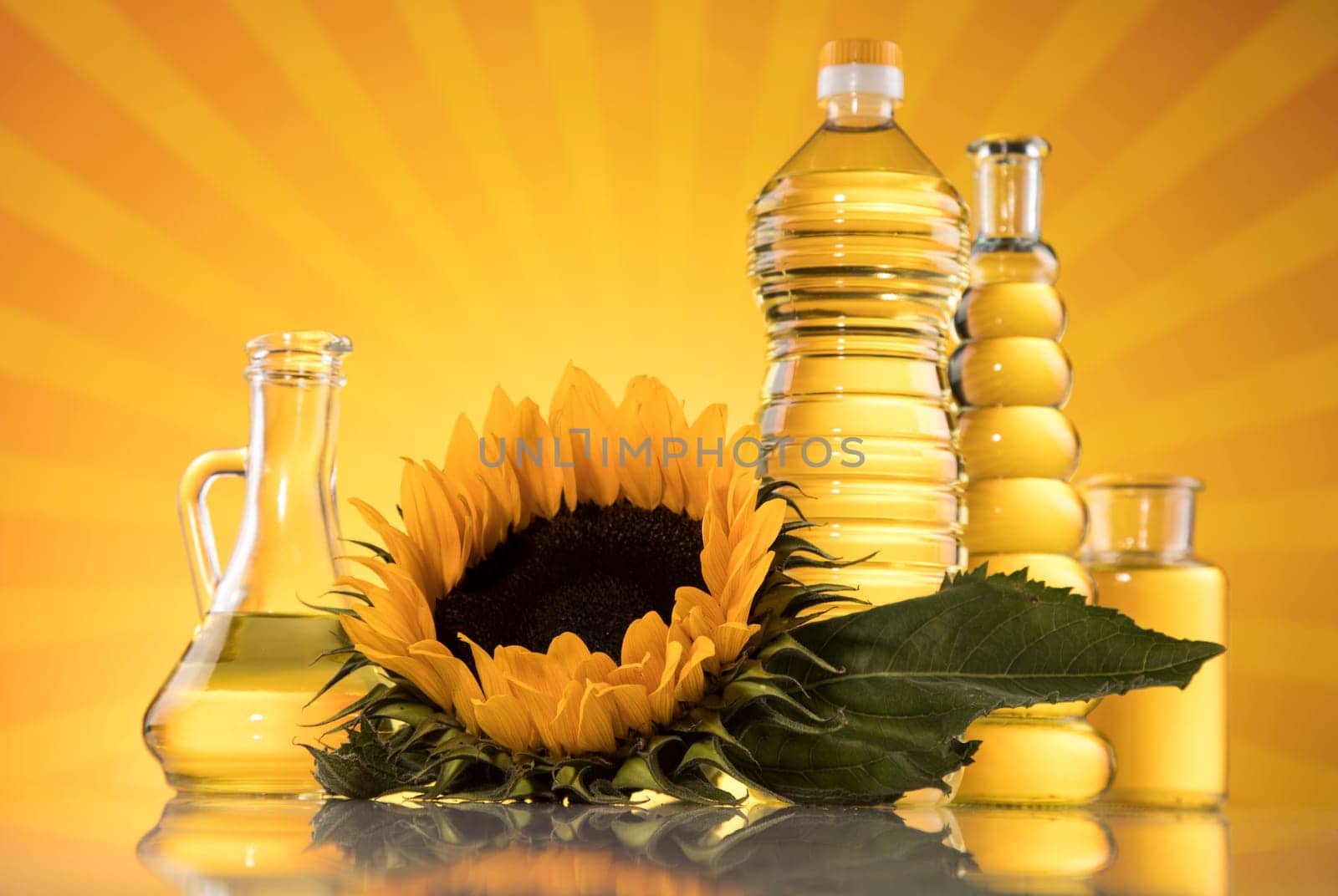 Sunflower oil, olive oil on sunburst orange background