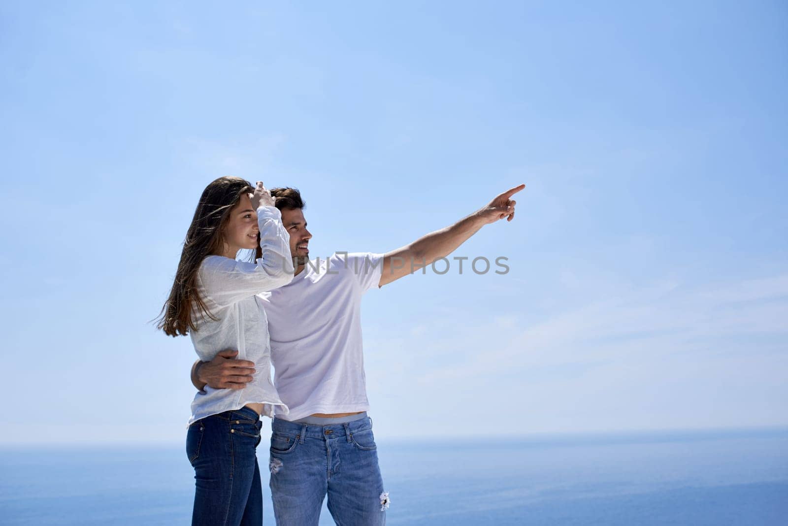 happy young romantic couple have fun relax smile at modern home outdoor terace balcony