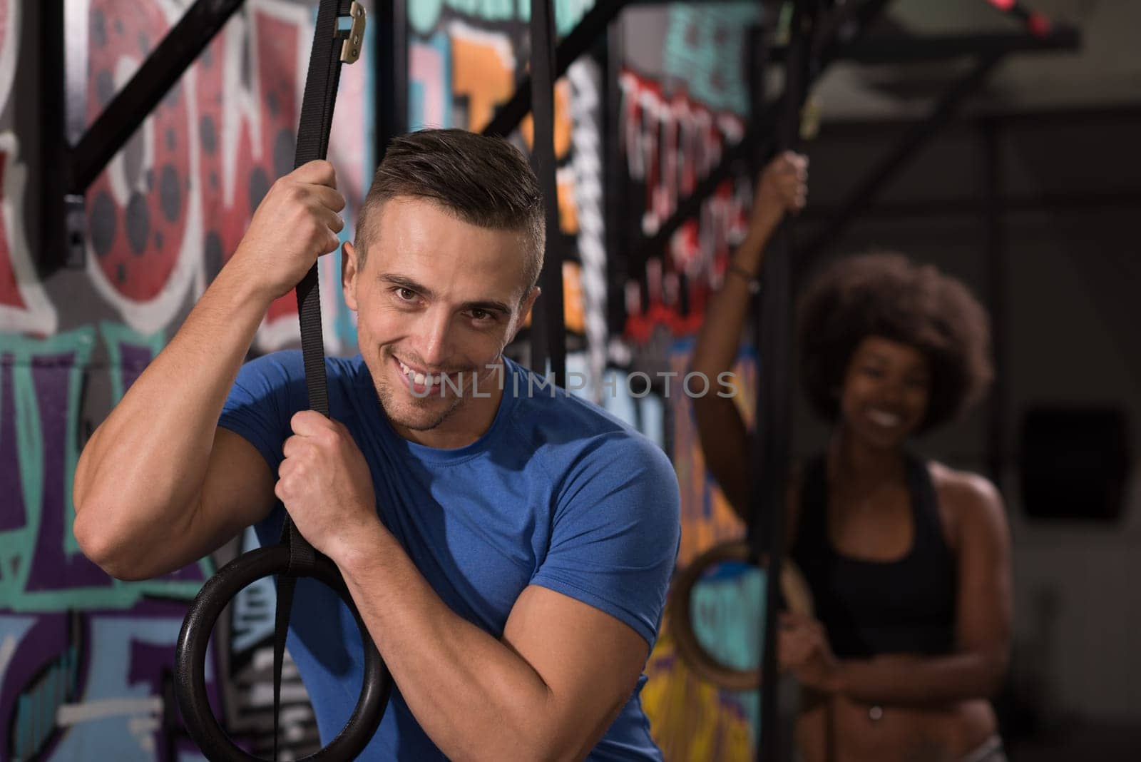 dip ring young man and african american woman relaxed after workout at gym dipping exercise