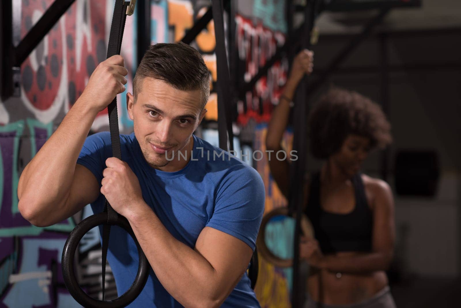 dip ring young man and african american woman relaxed after workout at gym dipping exercise