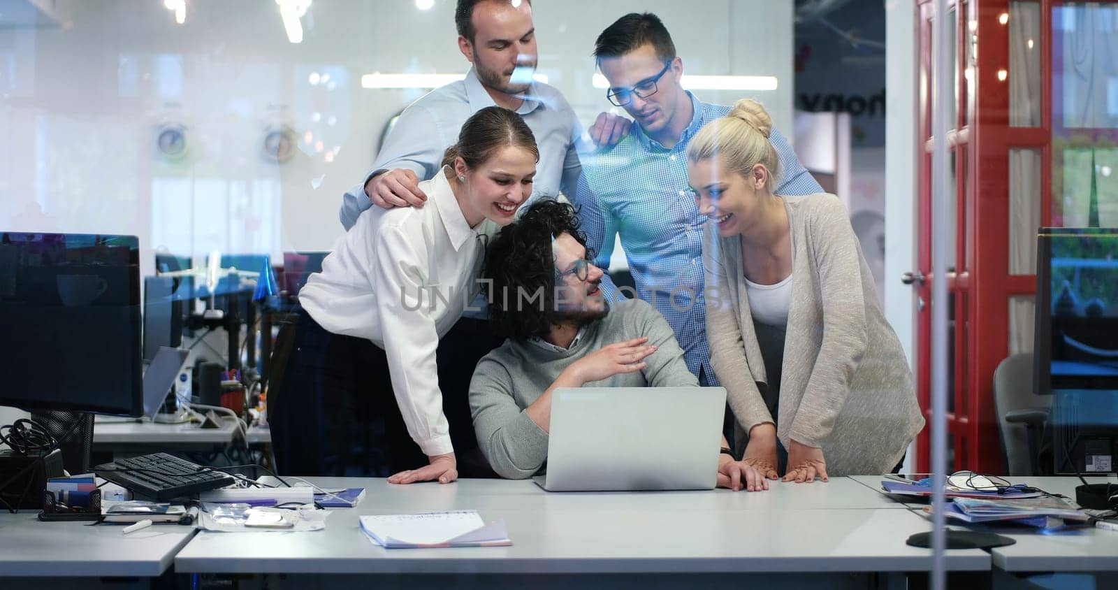 Group of a young business people discussing business plan at modern startup office building