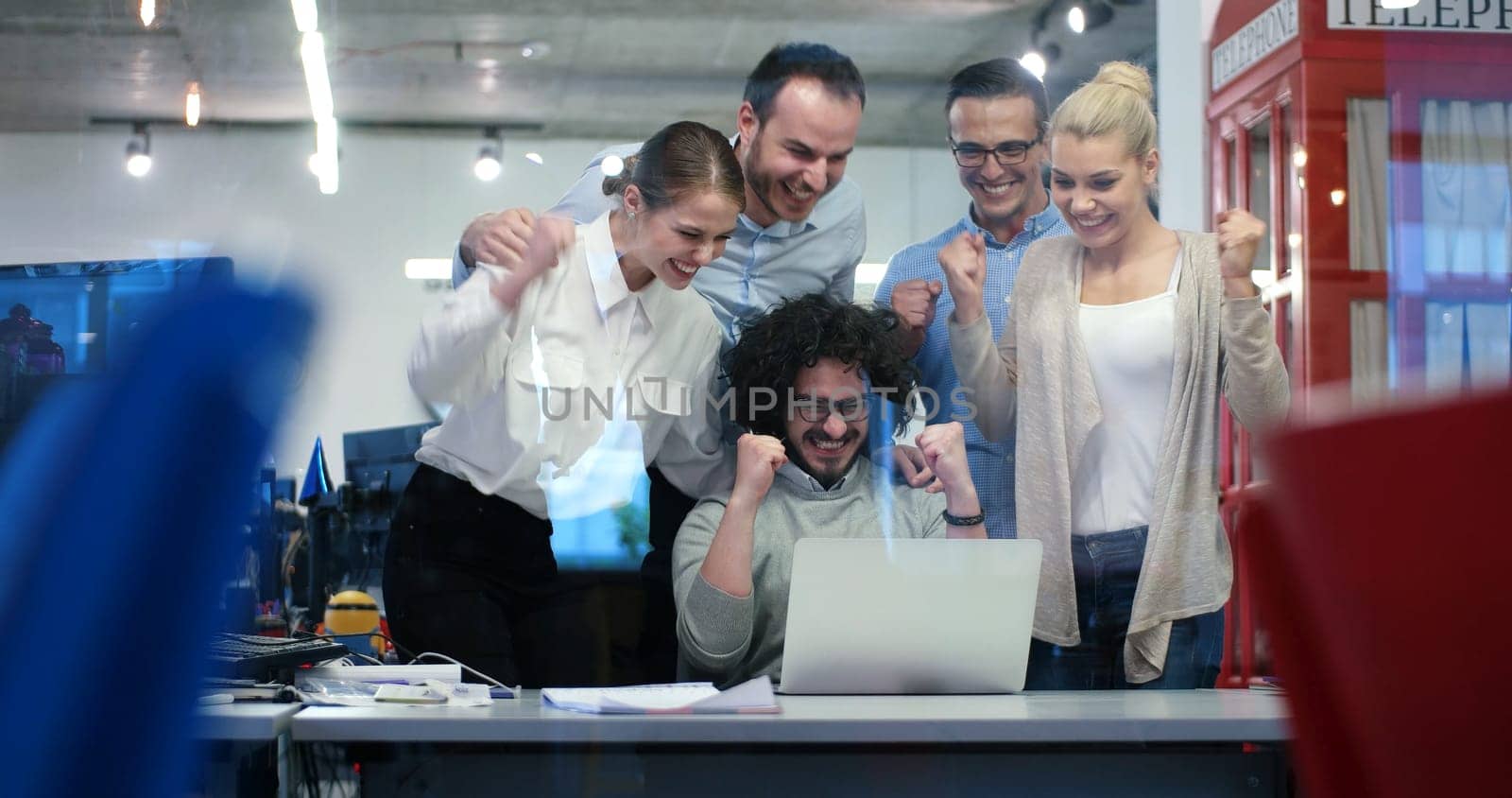 Group of a young business people discussing business plan at modern startup office building