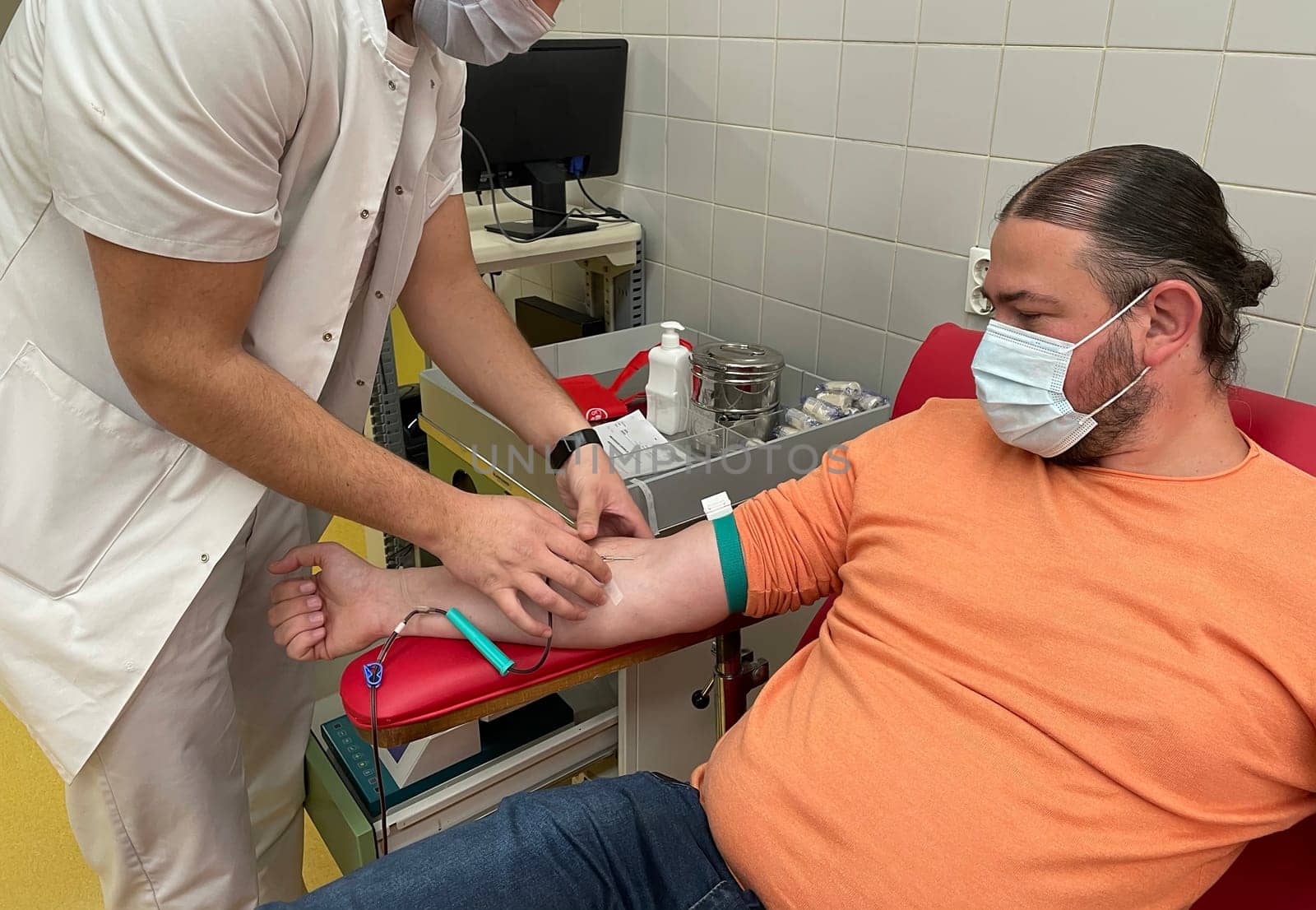 Close up nurse hand collecting blood sample for diagnosis covid-19, Coronavirus.Laboratory technician taking blood for blood chemistry diagnosis by automatic machine. High quality photo