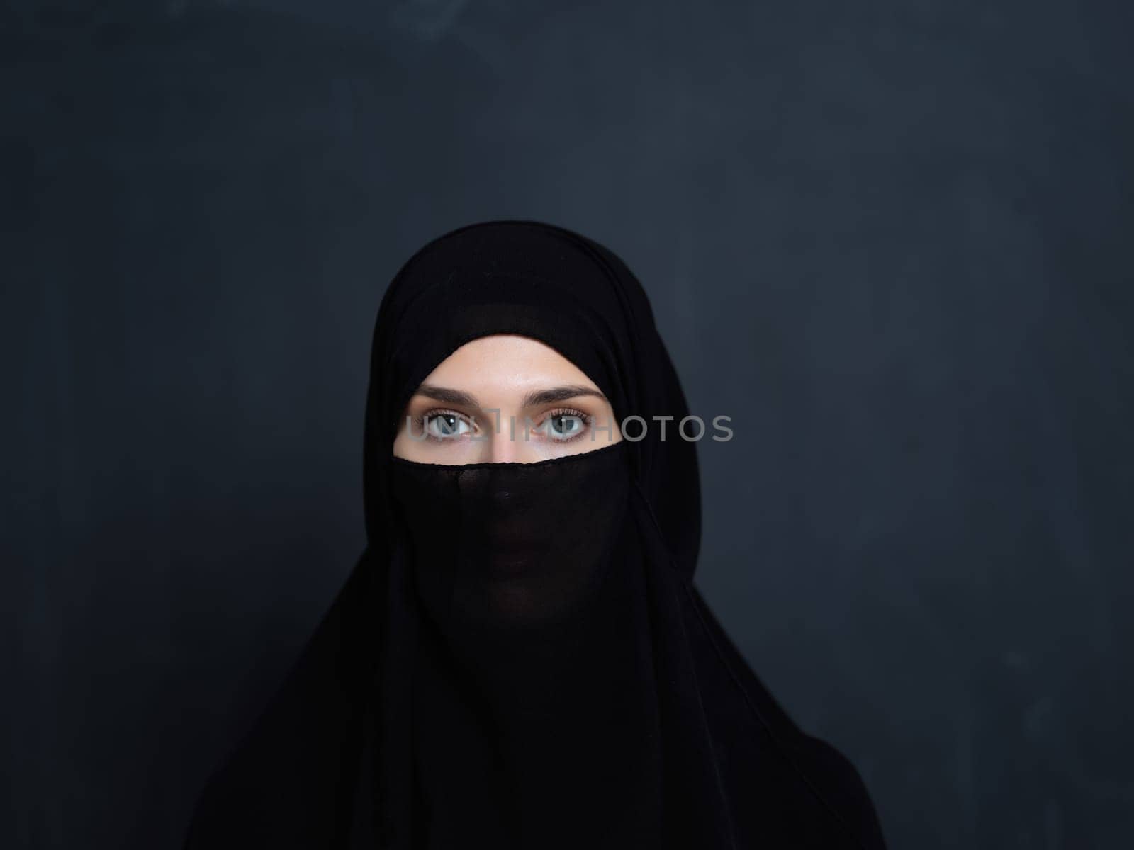 Portrait of muslim woman wearing niqab and traditional arabic clothes or abaya. Arab woman representing modern arabic lifestyle, islamic fashion and Ramadan kareem concept