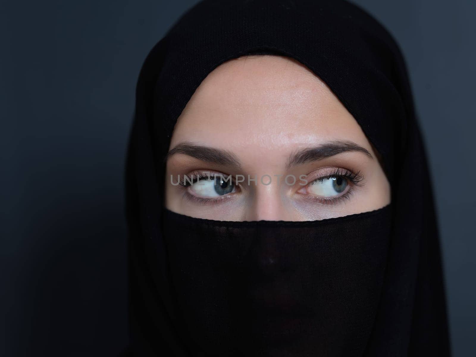 Portrait of muslim woman wearing niqab and traditional arabic clothes or abaya. Arab woman representing modern arabic lifestyle, islamic fashion and Ramadan kareem concept