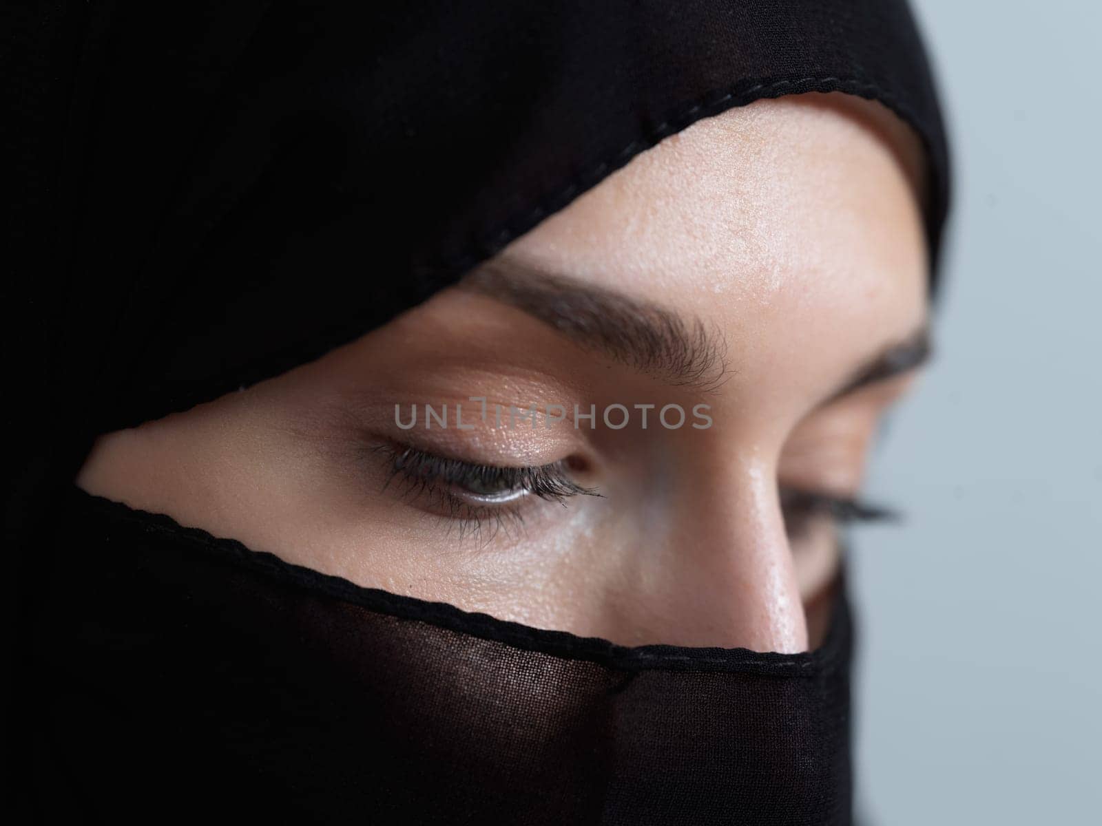 Portrait of muslim woman wearing niqab and traditional arabic clothes or abaya. Arab woman representing modern arabic lifestyle, islamic fashion and Ramadan kareem concept