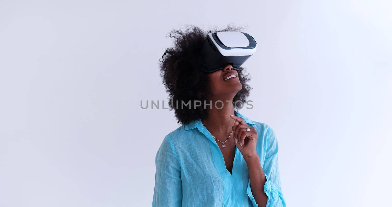Happy african american girl getting experience using VR headset glasses of virtual reality, isolated on white background