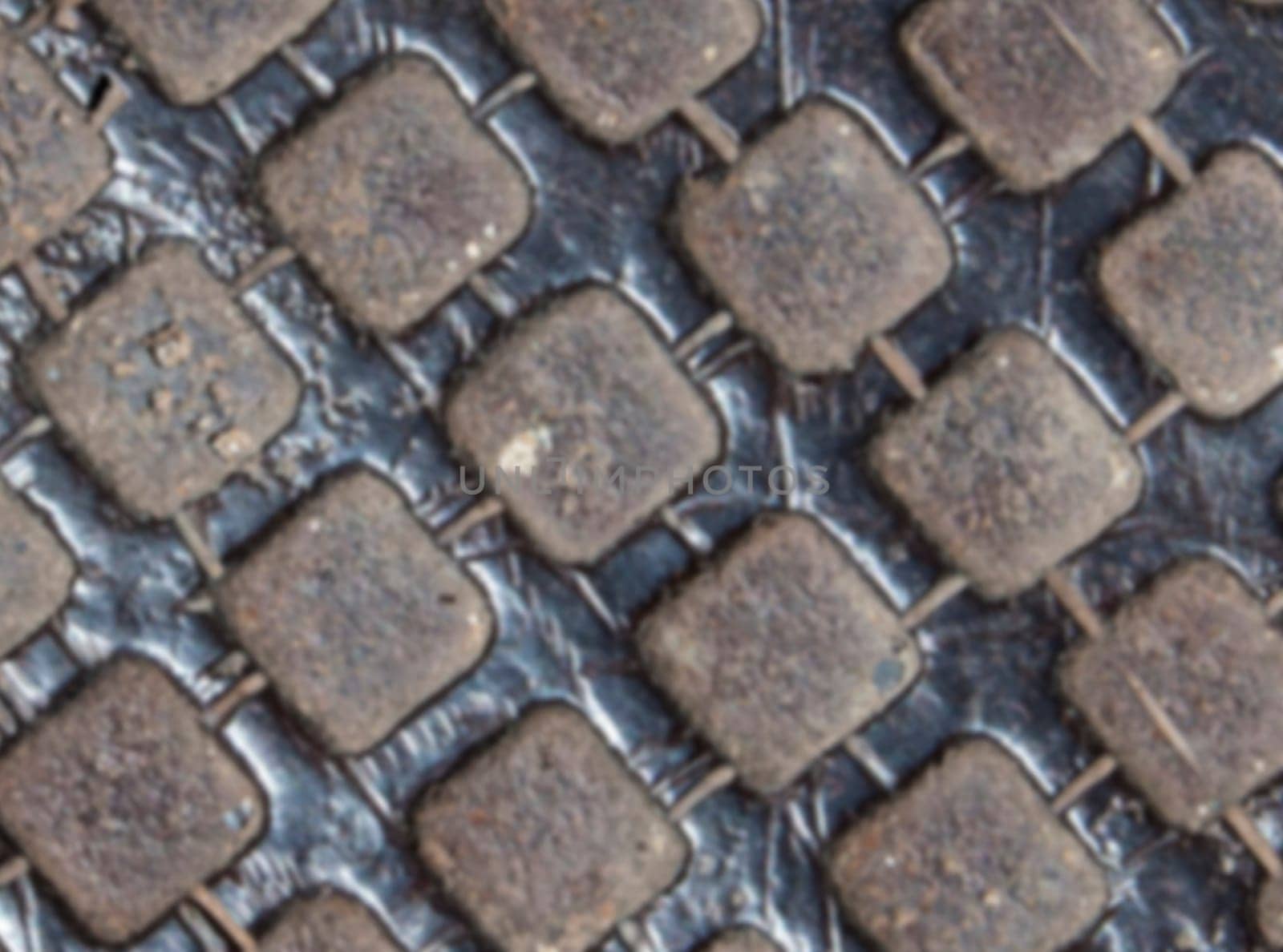 The blurred Detail of the pattern from a manhole cover
