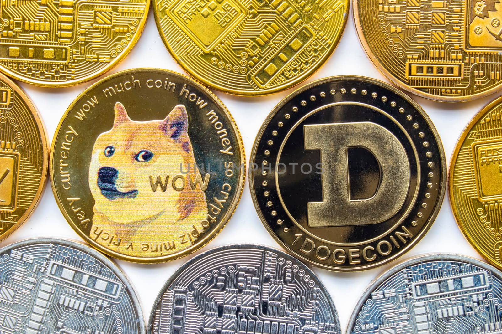 Calgary, Alberta, Canada. May 22, 2021. A couple of Dogecoin with several crypto currency coins around.