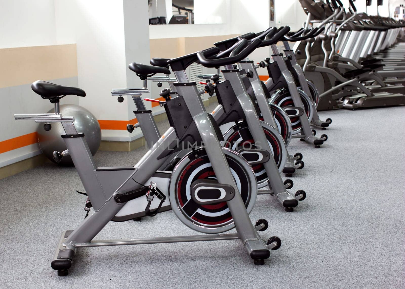 row sport's simulators and ball in gymnasium