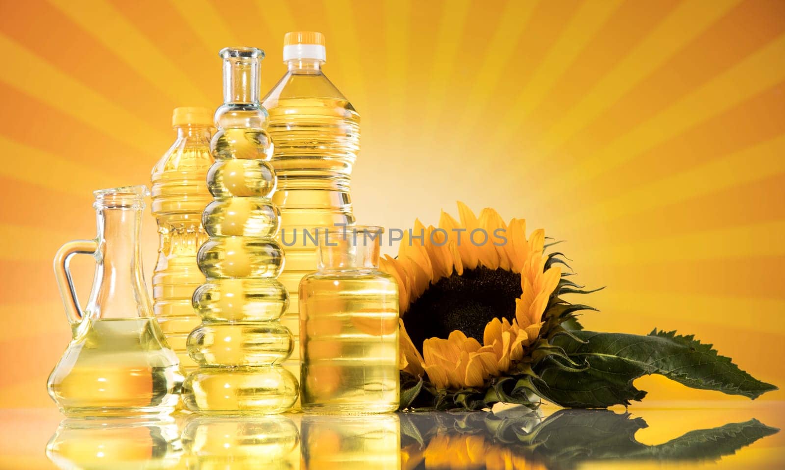 Sunflower oil, olive oil on sunburst orange background
