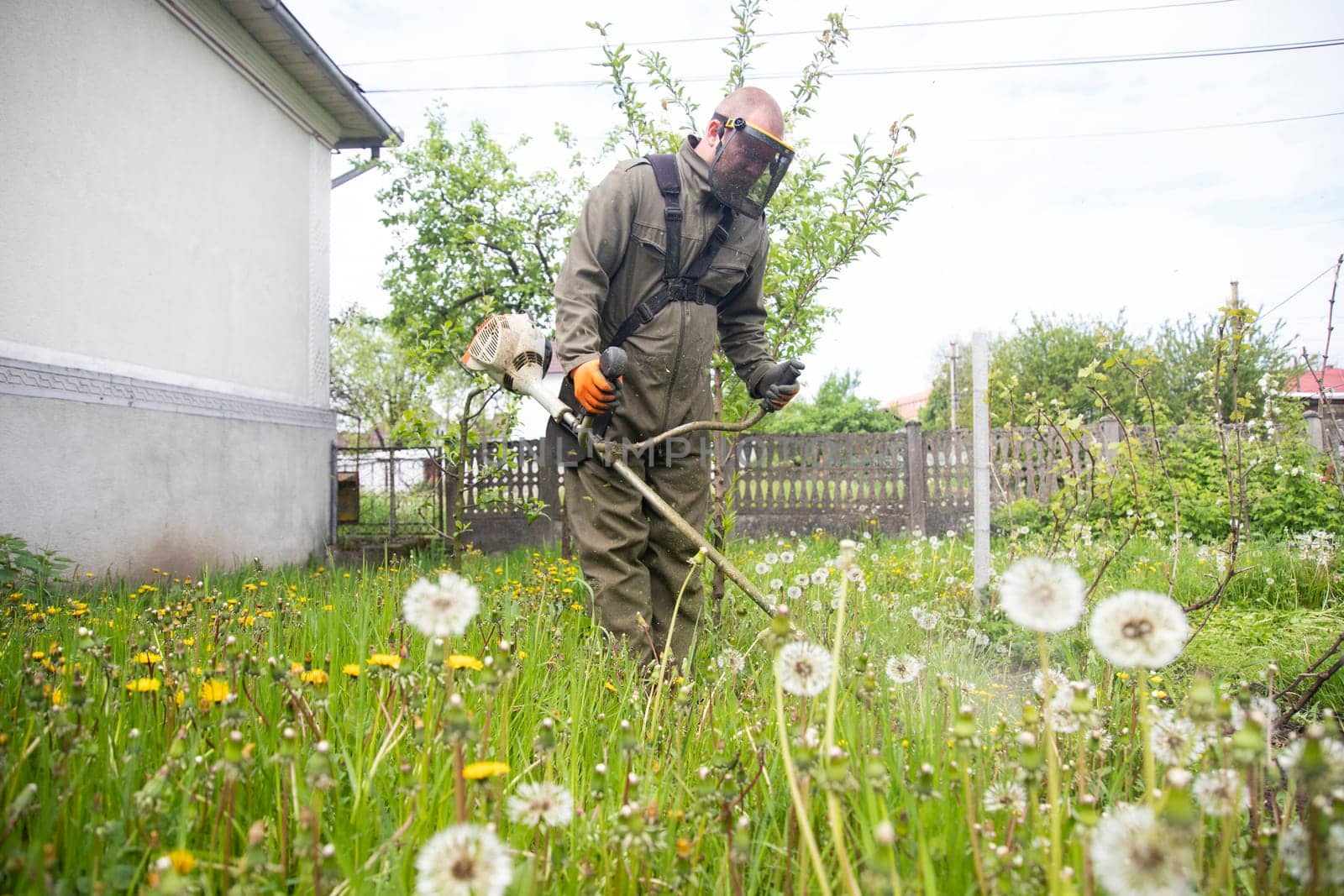 Mowing the grass with a lawn mower. Garden work concept background.