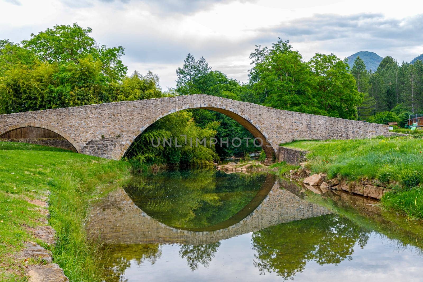 Medieval bridge over the Rialsesse river in Serres, France, located in the Aude department and the Languedoc Roussillon region.