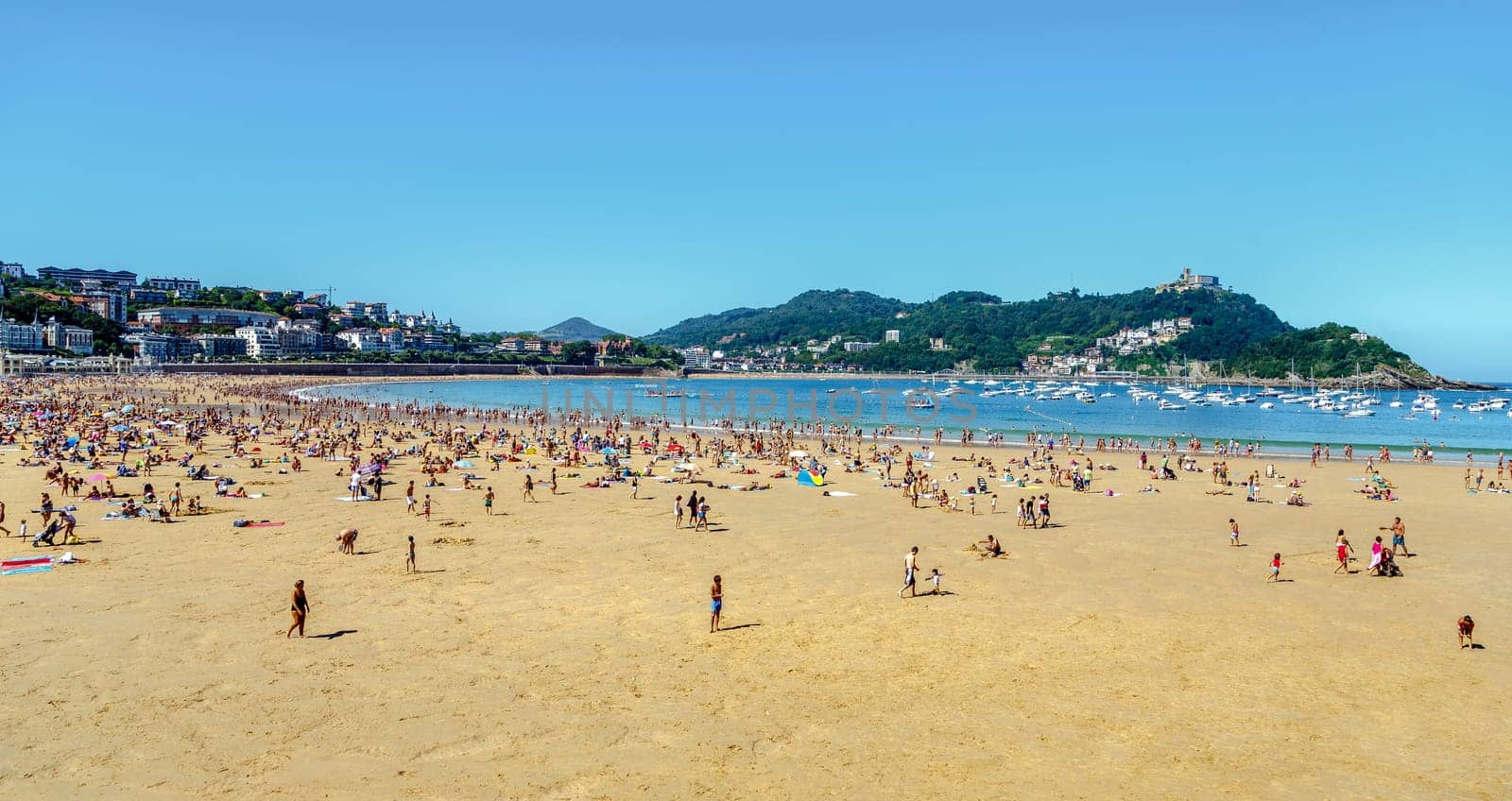 San Sebastian, Spain - August 22, 2016: Watches on the beach promenade of La Concha in San Sebastian in a sunny day on August