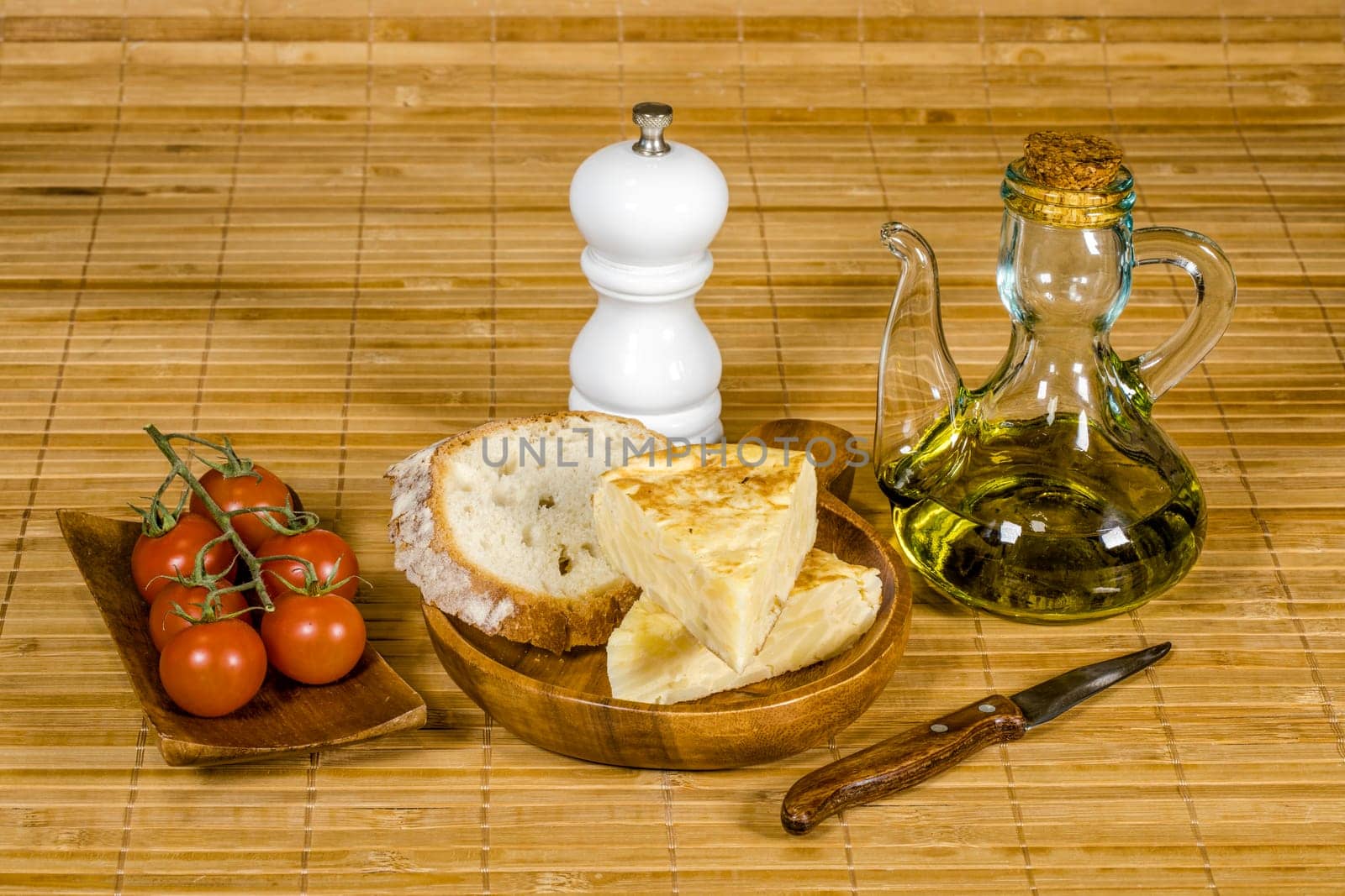 Spanish tortilla skewer presented in typical ration of Spain, With pure olive oil salt and bread with tomato