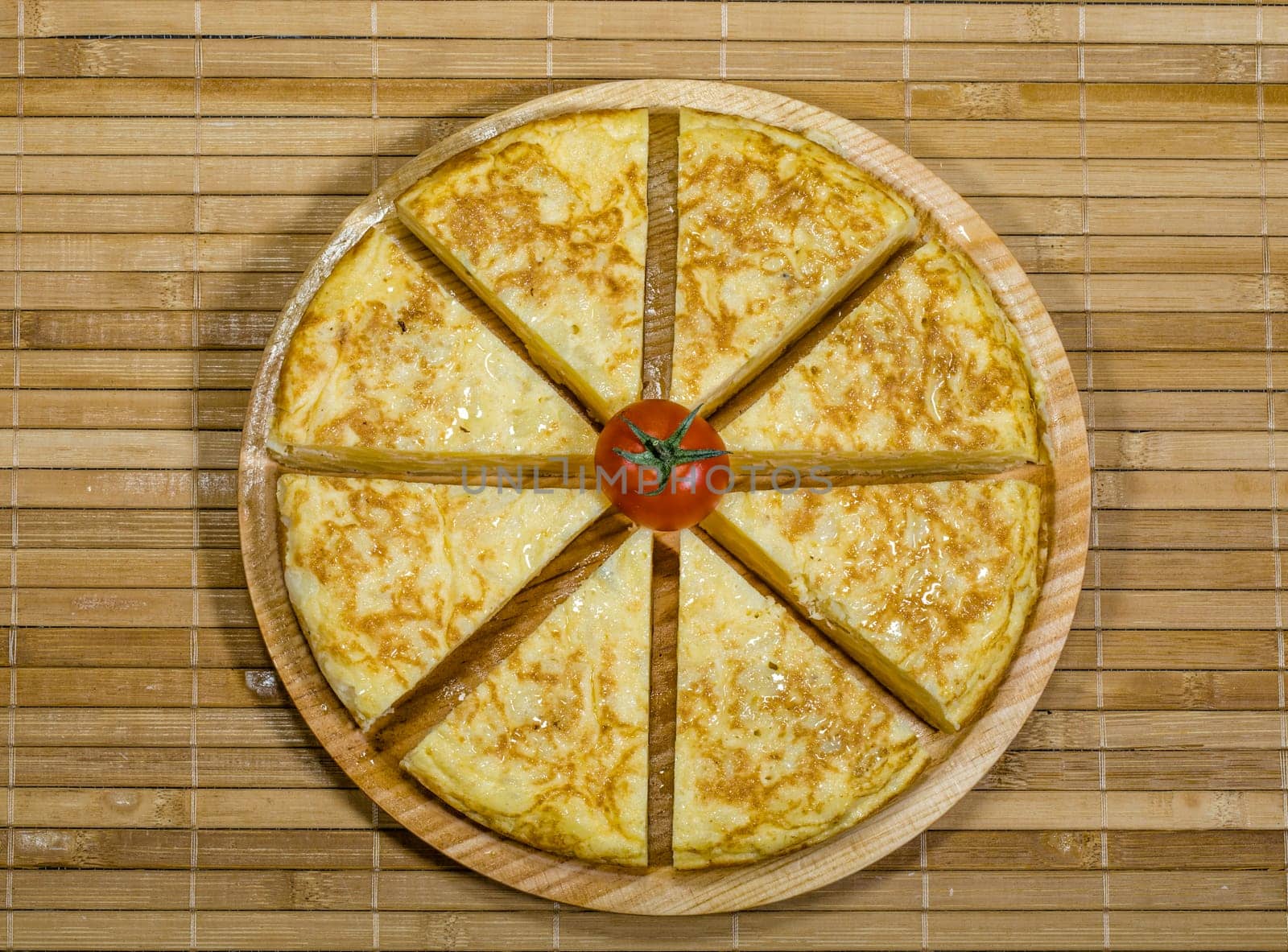 A triangle of potato Spanish omelette on a plate