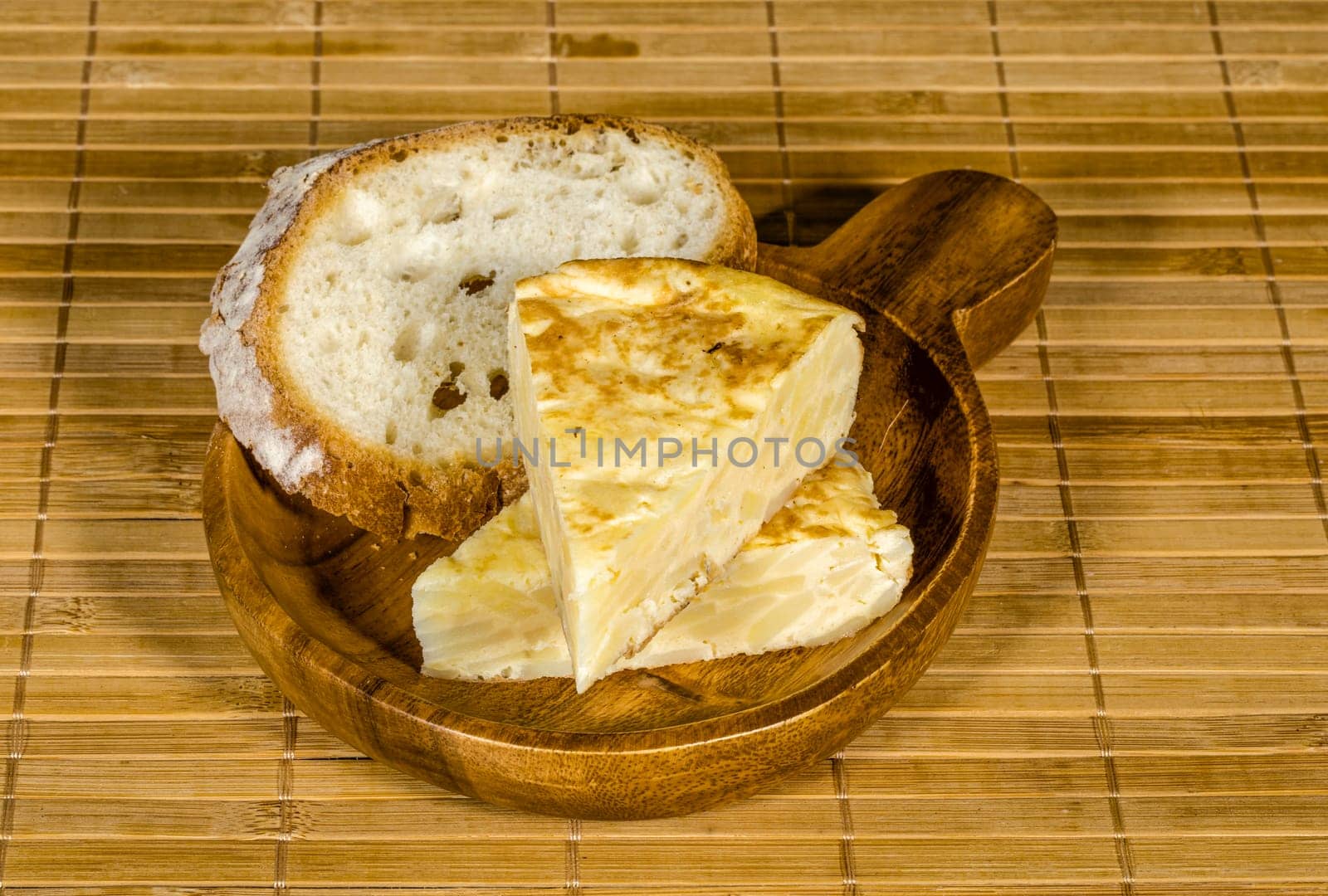 Spanish tortilla skewer presented in typical ration of Spain, With bread