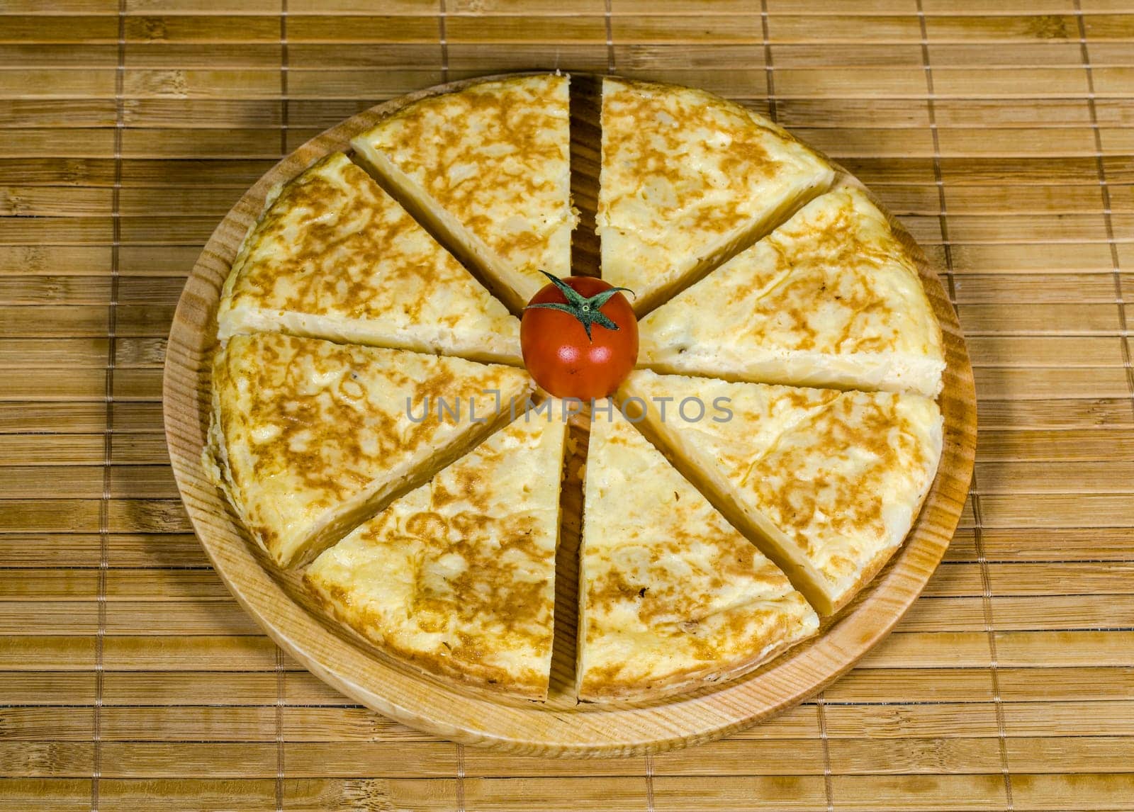 A triangle of potato Spanish omelette on a plate