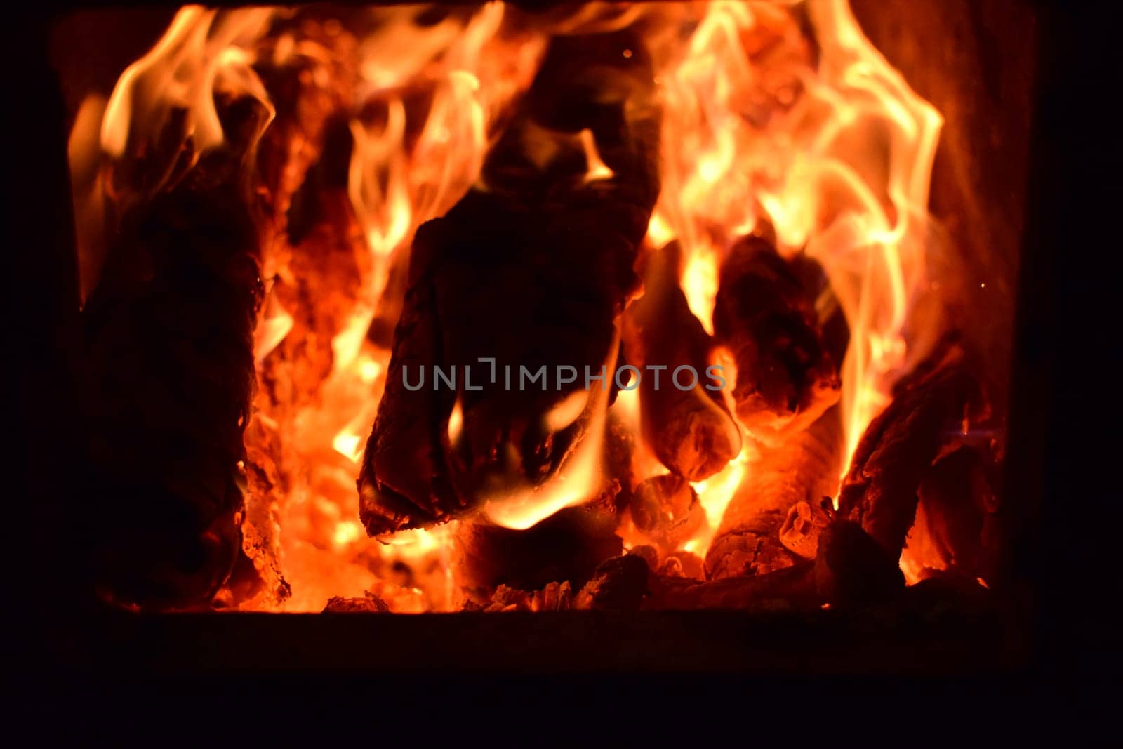 Hot coals in the stove. Red burned by heating the particles tree.