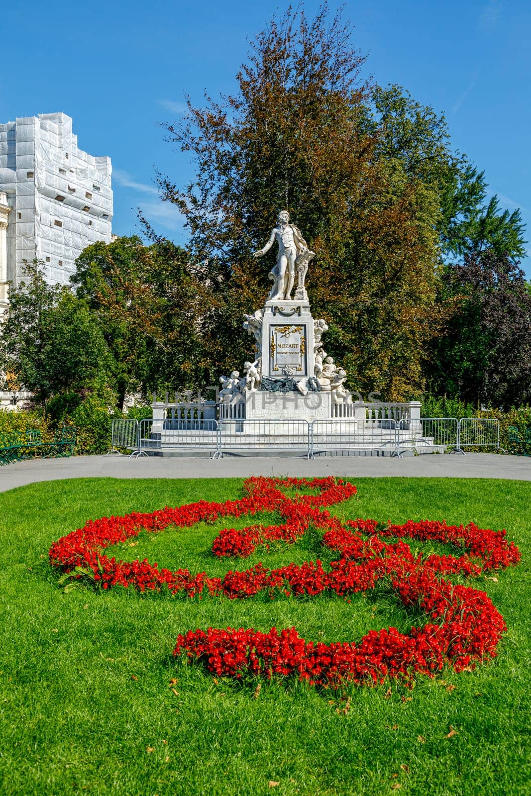 Mozart Statue with flower decoration in the form of a musical treble clef key, Vienna, Austria